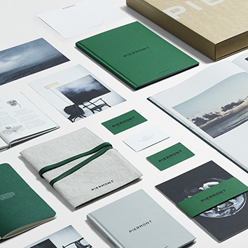 Aesthetic green and gray stationery set with notebooks, cards, and photos.
