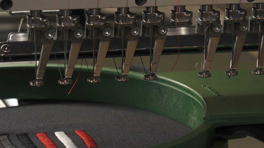 Close-up of a sewing machine stitching fabric with precision.